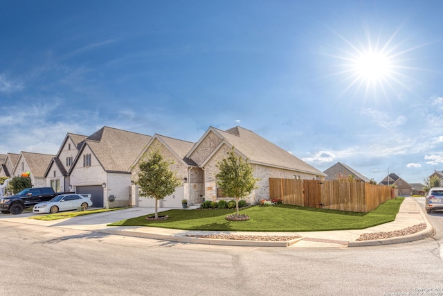 view of front of house with a front yard and a garage