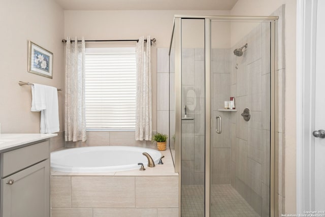 bathroom with vanity and separate shower and tub