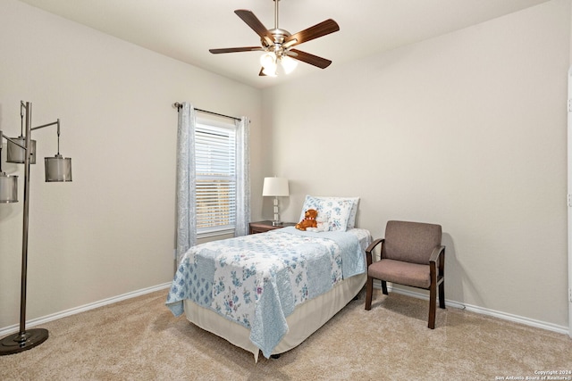 bedroom featuring ceiling fan and light carpet