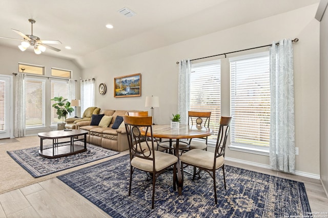 dining room with vaulted ceiling, ceiling fan, hardwood / wood-style flooring, and plenty of natural light