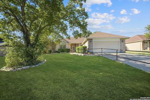 view of front of home with a front yard and a garage