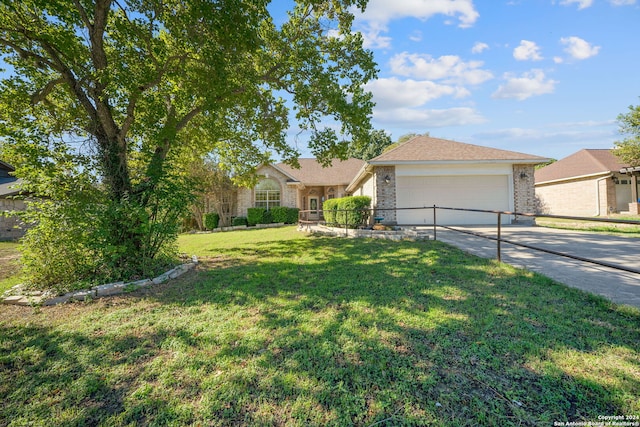 ranch-style house featuring a front lawn and a garage