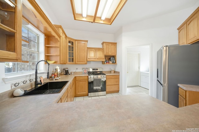 kitchen featuring sink, light tile patterned floors, and appliances with stainless steel finishes