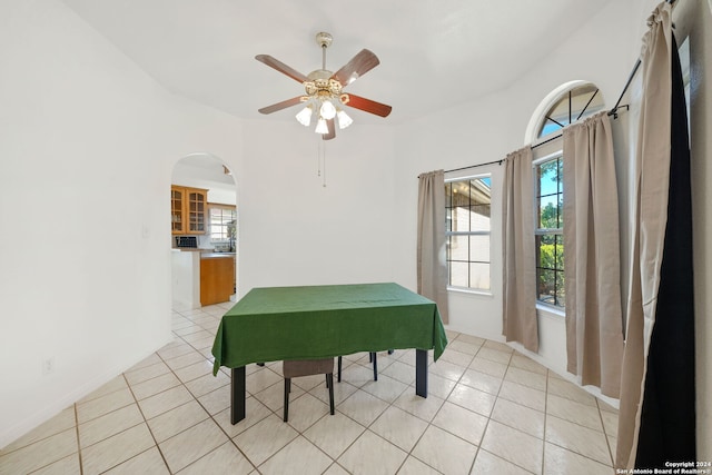 tiled dining space featuring ceiling fan