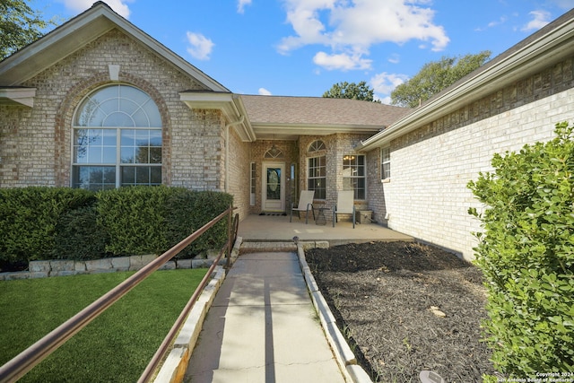 doorway to property with a yard