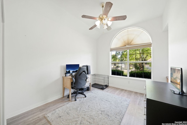 home office featuring ceiling fan, light hardwood / wood-style floors, and lofted ceiling