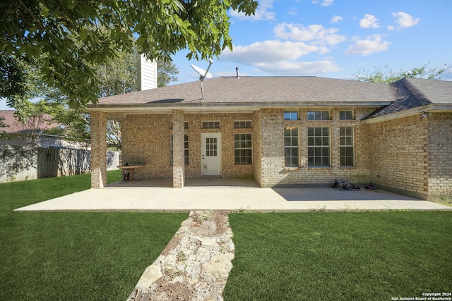 back of house with a patio area and a yard