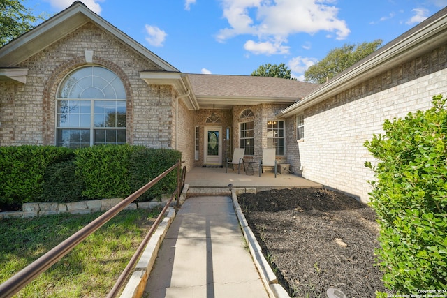 view of exterior entry with a porch