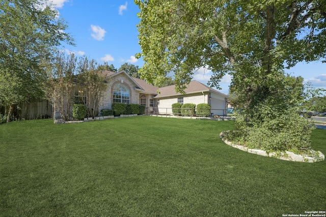 view of front of house featuring a front yard and a garage