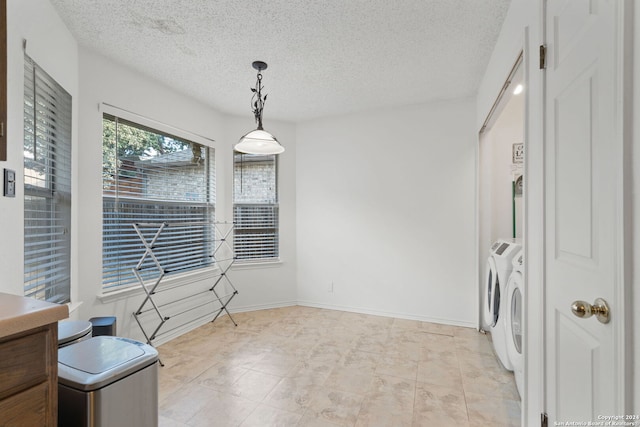 interior space featuring a textured ceiling and washing machine and dryer