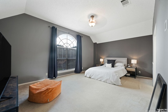 carpeted bedroom with ceiling fan and vaulted ceiling