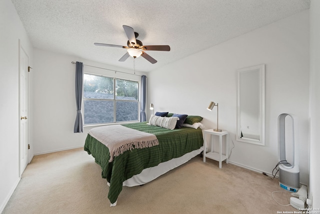 bedroom with light carpet, a textured ceiling, and ceiling fan