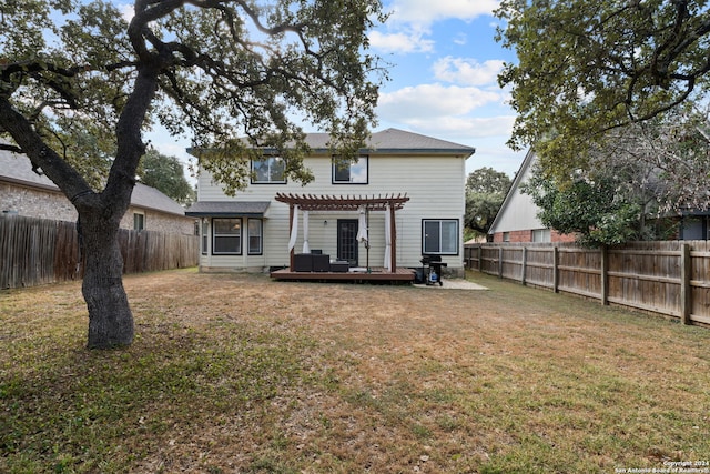 rear view of house featuring a pergola, a deck, and a yard