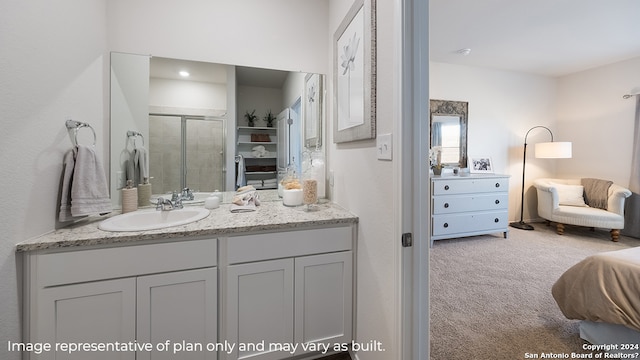 bathroom featuring vanity and a shower with door