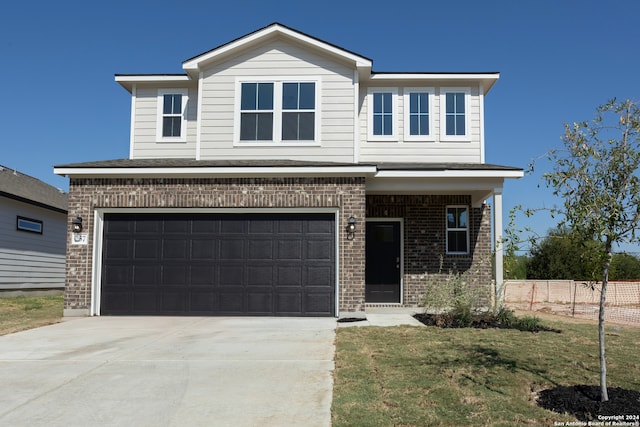 view of front of property featuring a garage and a front yard