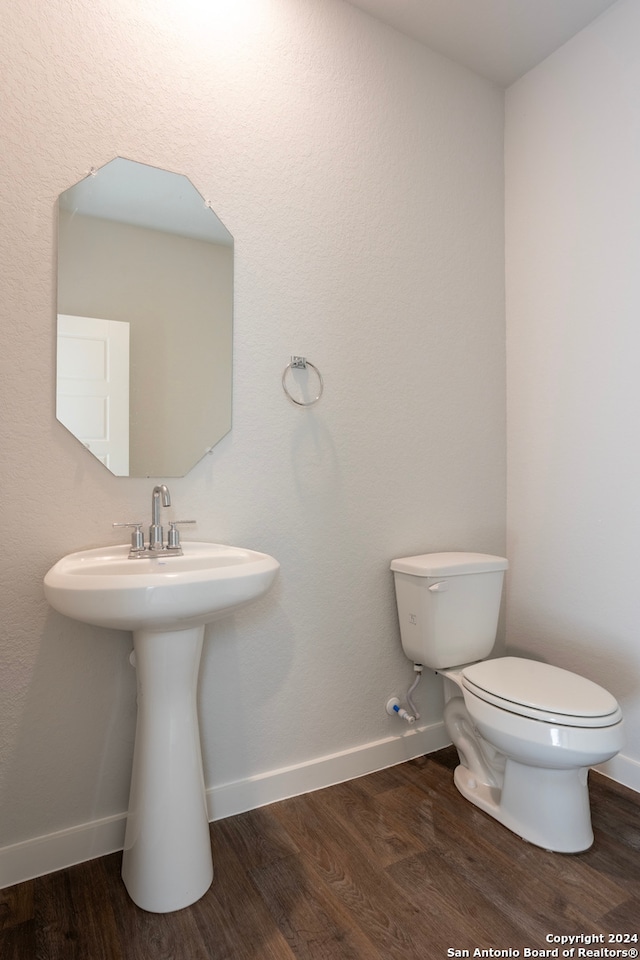 bathroom with toilet and hardwood / wood-style flooring