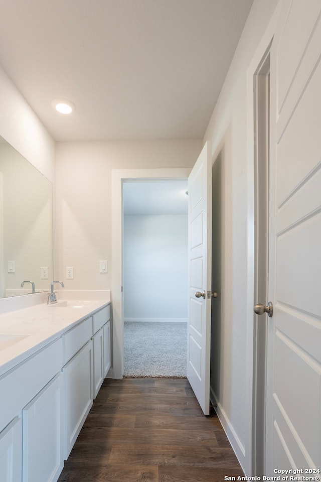 bathroom featuring wood-type flooring and vanity