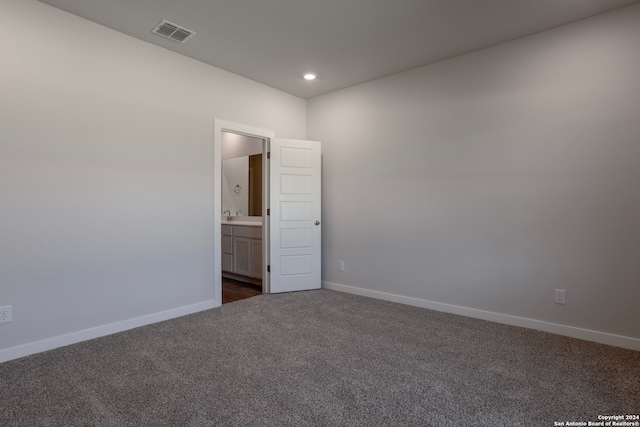 empty room featuring dark colored carpet