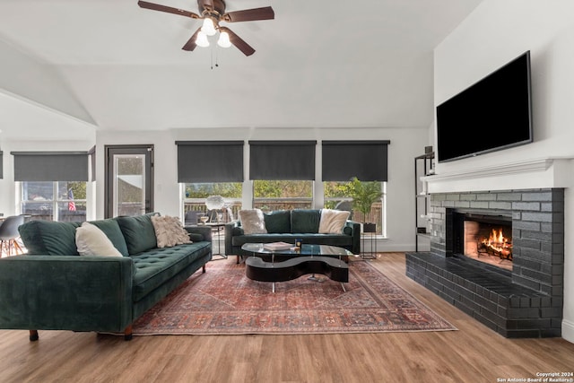 living room with lofted ceiling, wood-type flooring, and plenty of natural light