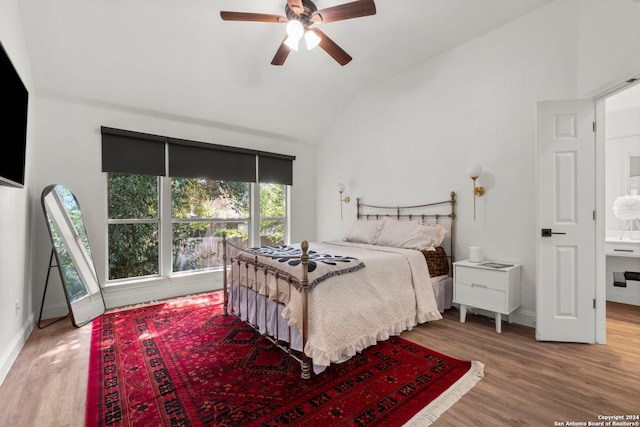 bedroom with ceiling fan, wood-type flooring, and vaulted ceiling