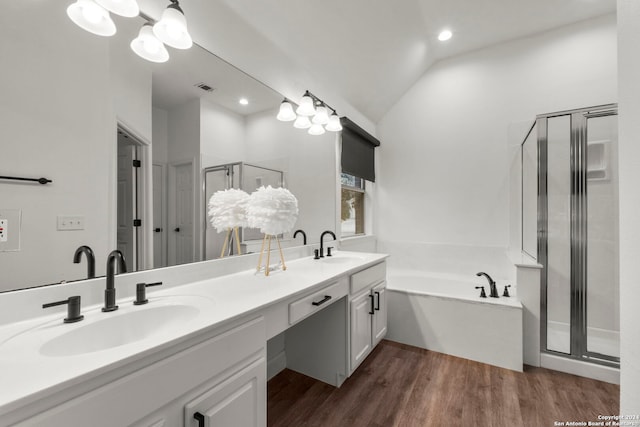 bathroom with vanity, shower with separate bathtub, hardwood / wood-style flooring, and vaulted ceiling