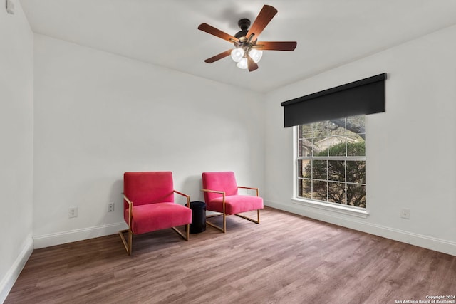 sitting room with wood-type flooring and ceiling fan