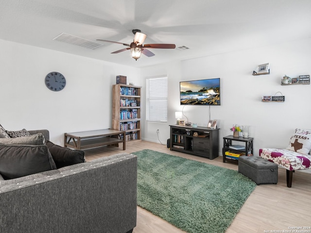 living room featuring ceiling fan and hardwood / wood-style floors