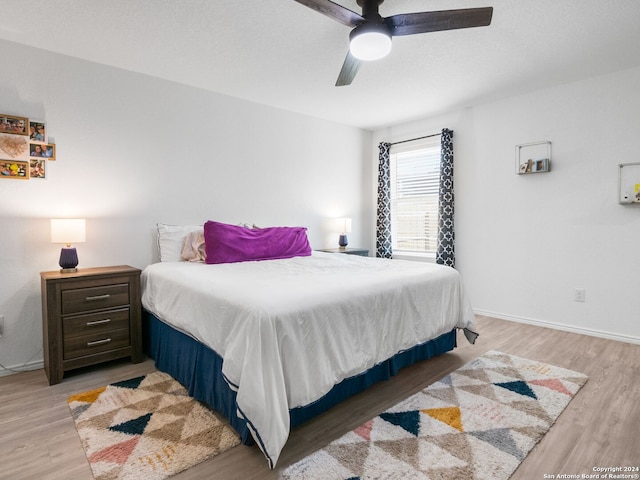 bedroom with ceiling fan and light hardwood / wood-style floors