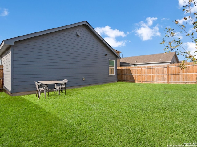 back of house with a yard