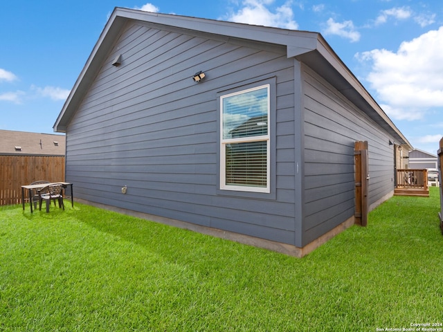 view of side of property with a yard