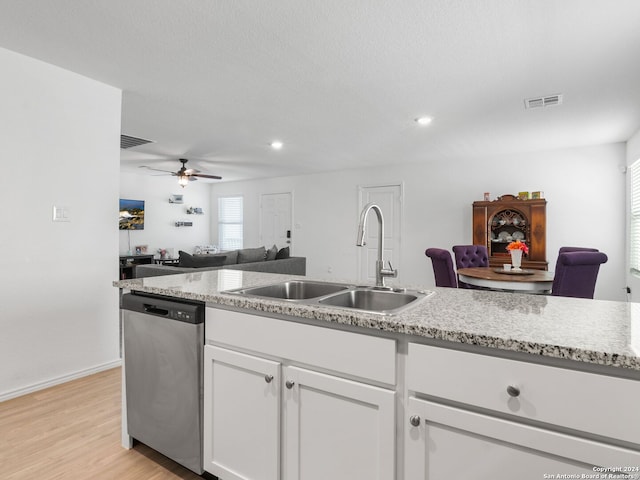 kitchen featuring sink, stainless steel dishwasher, white cabinetry, light hardwood / wood-style floors, and ceiling fan