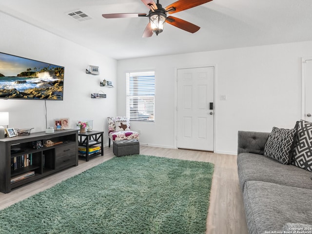 living room with ceiling fan and hardwood / wood-style flooring