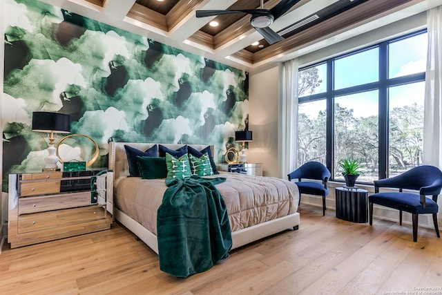 bedroom featuring beam ceiling, hardwood / wood-style floors, coffered ceiling, and ceiling fan