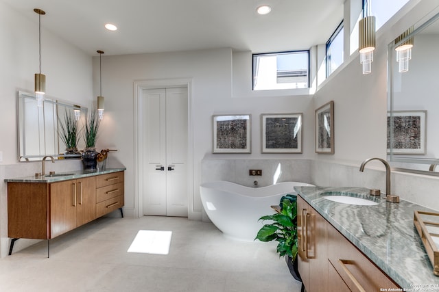 bathroom featuring vanity, a tub to relax in, and tile patterned floors