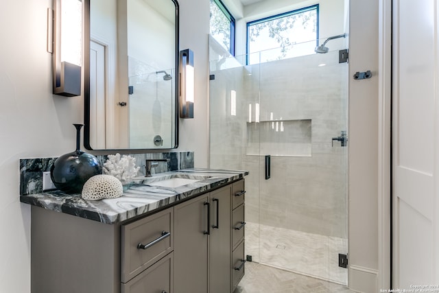 bathroom featuring vanity and an enclosed shower