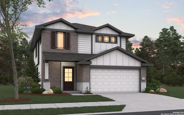 view of front of home with a lawn and a garage