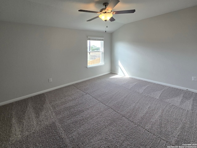 carpeted spare room with ceiling fan and lofted ceiling