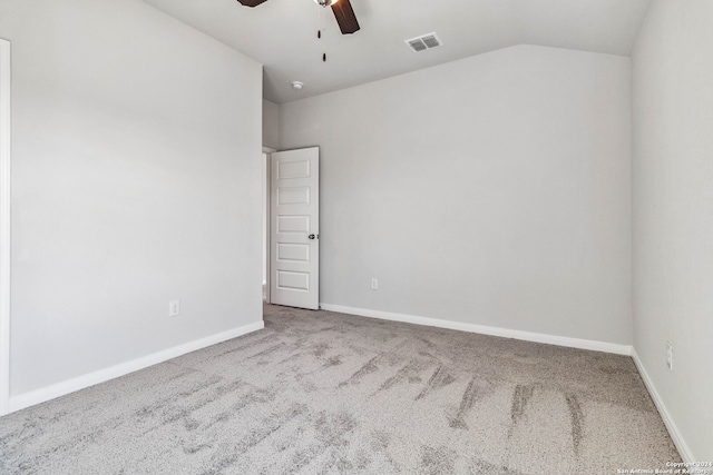 carpeted empty room featuring lofted ceiling and ceiling fan