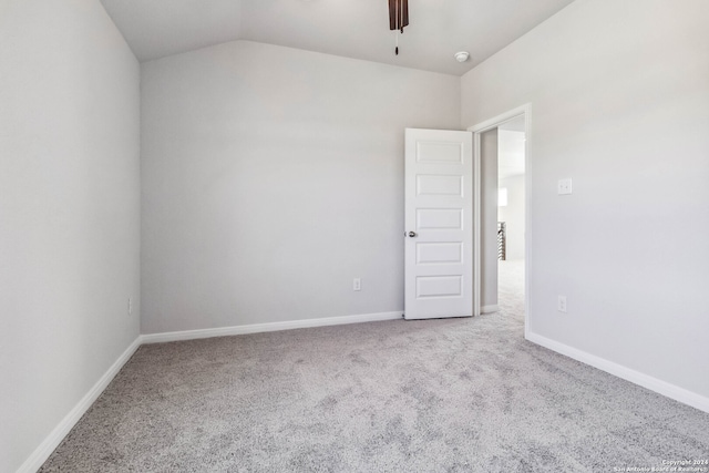 empty room featuring lofted ceiling and light carpet