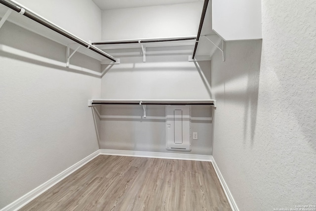 spacious closet with light hardwood / wood-style flooring