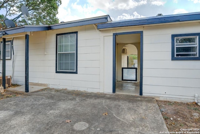 view of side of home with a patio