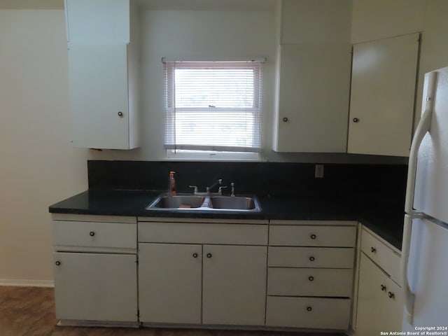 kitchen featuring white fridge and white cabinets