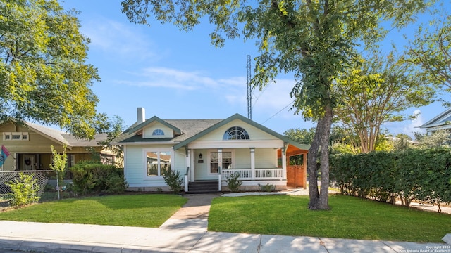 view of front facade featuring a front lawn and covered porch