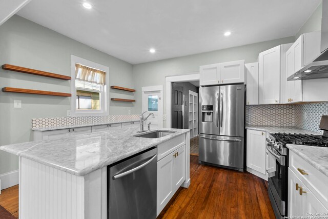 214 Loretta Pl, San Antonio, TX 78210 - kitchen with appliances with stainless steel finishes, open shelves, a sink, wall chimney exhaust hood, and decorative backsplash