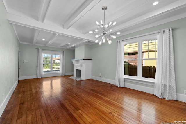 214 Loretta Pl, San Antonio, TX 78210 - unfurnished living room with hardwood / wood-style floors, a chandelier, beam ceiling, baseboards, and a fireplace