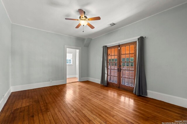 unfurnished room with ceiling fan, french doors, and hardwood / wood-style floors