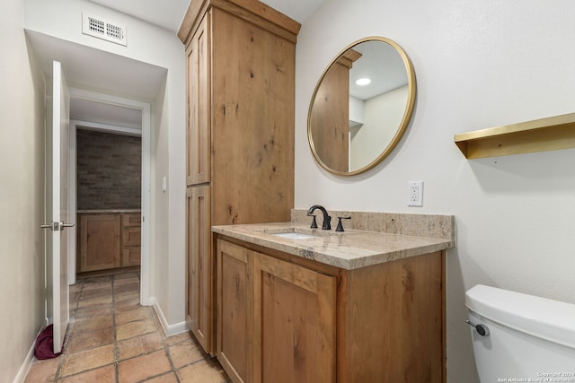 bathroom with toilet and vanity