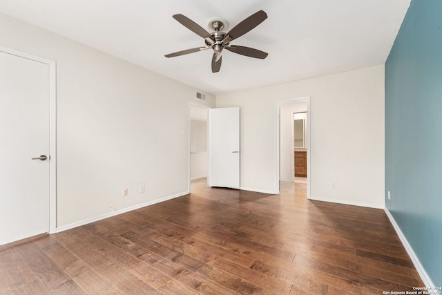 spare room featuring ceiling fan and dark hardwood / wood-style flooring