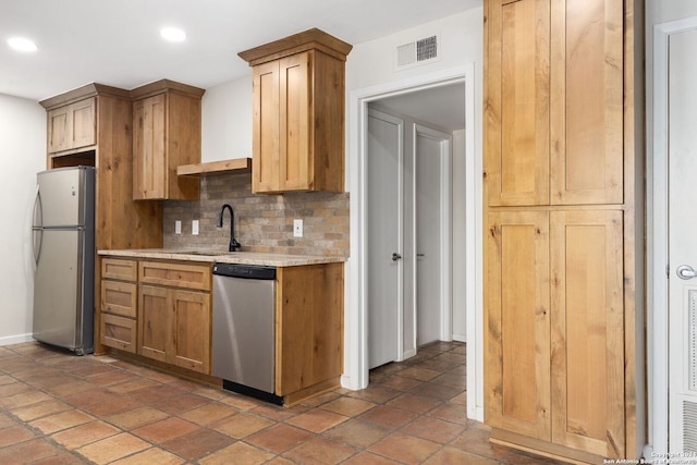 kitchen featuring tasteful backsplash, stainless steel appliances, and sink