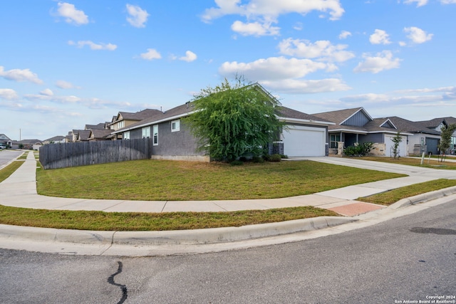 view of front of property with a front lawn and a garage